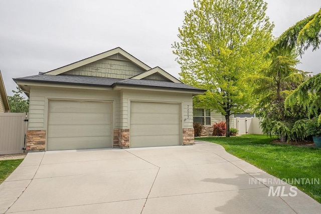 7053 W Butte Ln, Boise, ID 83704 - craftsman house featuring stone siding, concrete driveway, and a garage