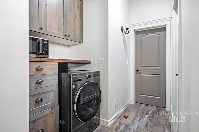 washroom with cabinets, washer / clothes dryer, and hardwood / wood-style floors