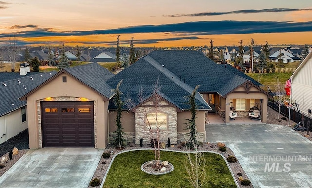 view of front of house with a garage and a yard