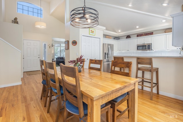 dining space with an inviting chandelier, recessed lighting, baseboards, and light wood finished floors