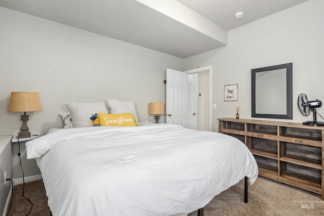 carpeted bedroom featuring baseboards