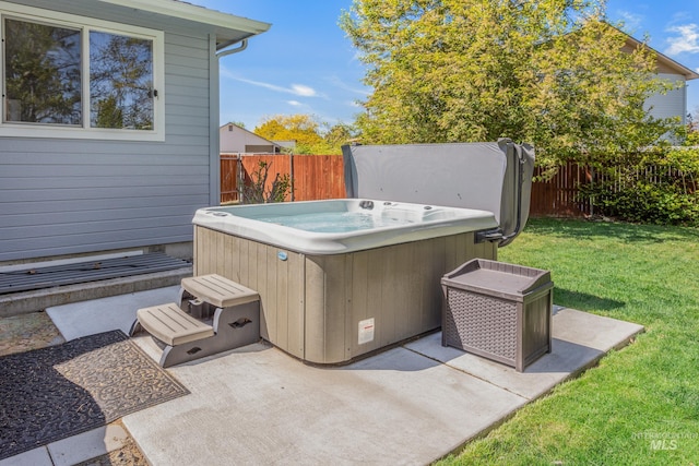 view of patio / terrace with a fenced backyard and a hot tub