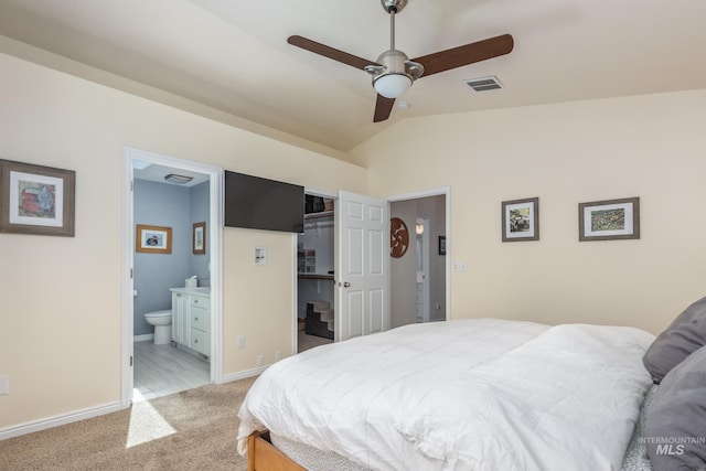 bedroom with light carpet, baseboards, ensuite bathroom, lofted ceiling, and visible vents