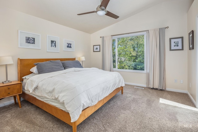 carpeted bedroom with baseboards, a ceiling fan, vaulted ceiling, and visible vents