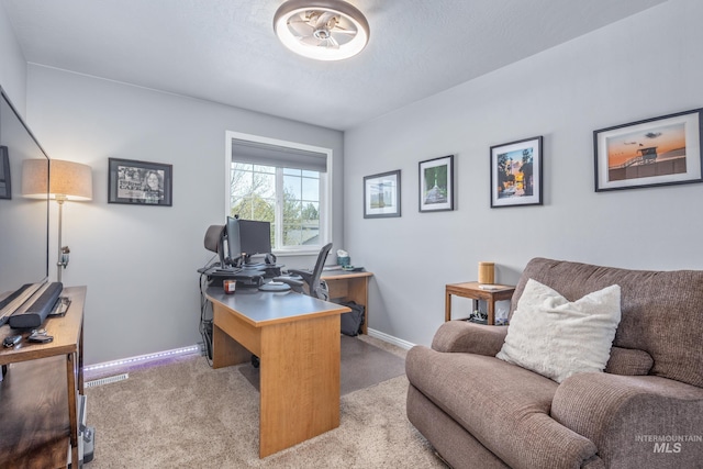 office space featuring baseboards and light colored carpet