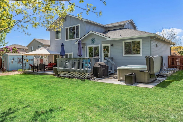 rear view of house with a gazebo, a hot tub, a storage shed, an outdoor living space, and a patio