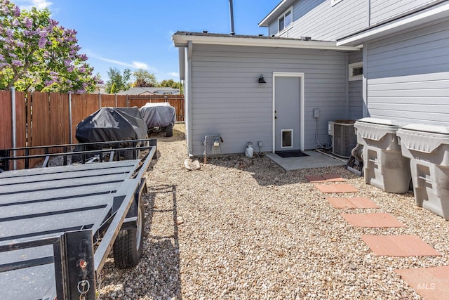 exterior space featuring central AC, area for grilling, and fence