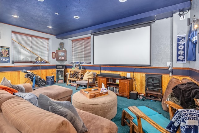 carpeted cinema room with recessed lighting, wood walls, and wainscoting