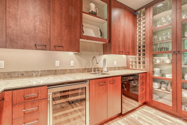 705 N Cobblestone Way, Eagle, ID 83616 - kitchen with wine cooler, dishwasher, light stone countertops, light wood-type flooring, and glass insert cabinets