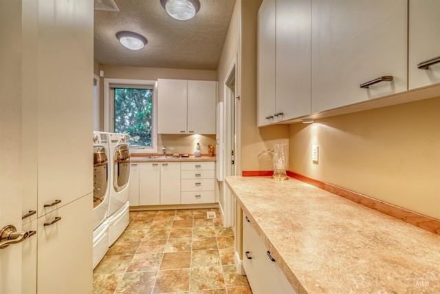 705 N Cobblestone Way, Eagle, ID 83616 - kitchen with independent washer and dryer, light countertops, a sink, white cabinetry, and light stone finish flooring