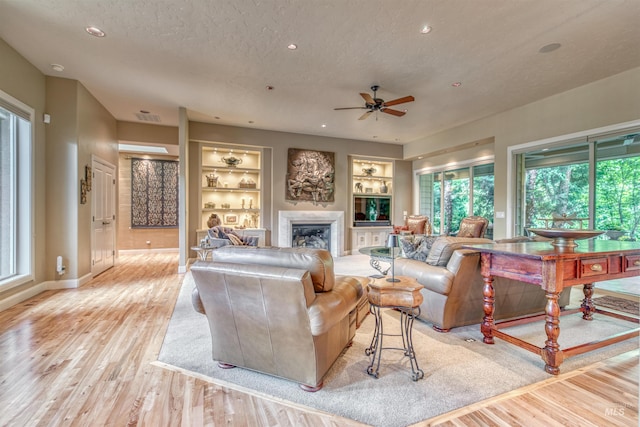 705 N Cobblestone Way, Eagle, ID 83616 - living room with light wood finished floors, healthy amount of natural light, ceiling fan, a textured ceiling, and recessed lighting