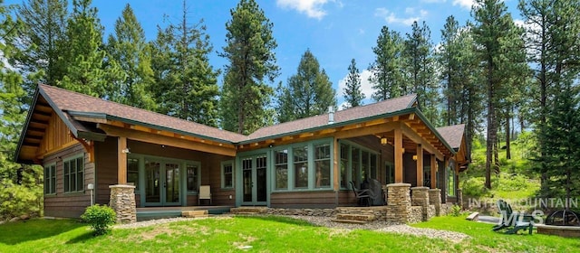 1460 Crown Point Pkwy, Cascade, ID 83611 - rear view of property with roof with shingles, french doors, stone siding, and a yard
