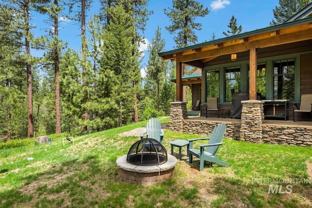 1460 Crown Point Pkwy, Cascade, ID 83611 - view of yard featuring an outdoor fire pit and a porch