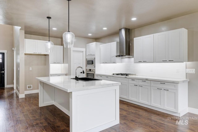 1113 W Blaine Ave, Nampa, ID 83651 - kitchen with tasteful backsplash, white cabinets, wall chimney exhaust hood, dark wood-style floors, and stainless steel appliances