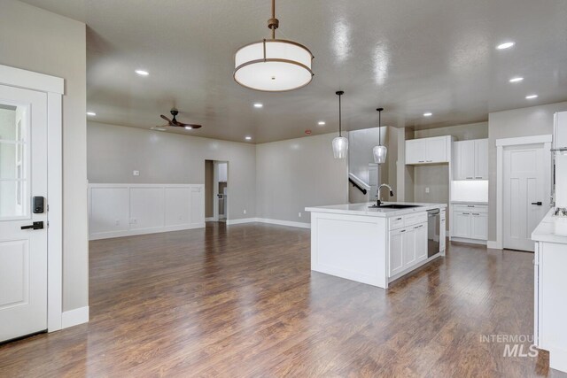 1113 W Blaine Ave, Nampa, ID 83651 - kitchen with light countertops, a sink, white cabinets, and hanging light fixtures