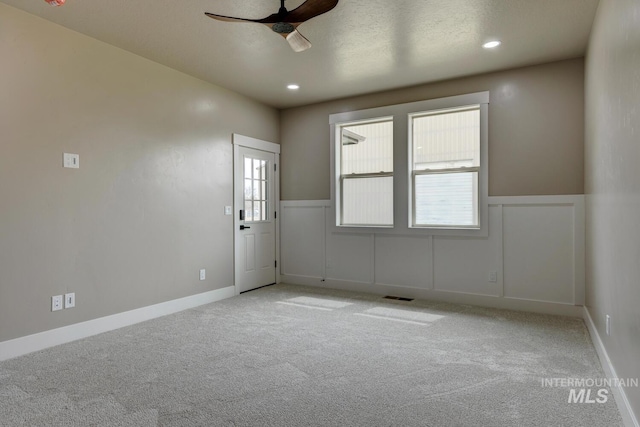 1113 W Blaine Ave, Nampa, ID 83651 - empty room featuring a wainscoted wall, a ceiling fan, visible vents, and carpet floors