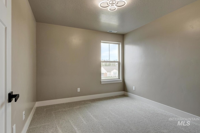 1113 W Blaine Ave, Nampa, ID 83651 - carpeted spare room with a textured ceiling, baseboards, and visible vents