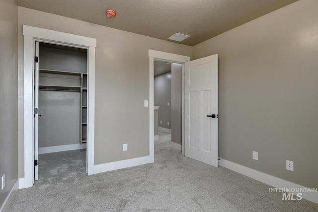 1113 W Blaine Ave, Nampa, ID 83651 - unfurnished bedroom with a closet, baseboards, a walk in closet, visible vents, and carpet