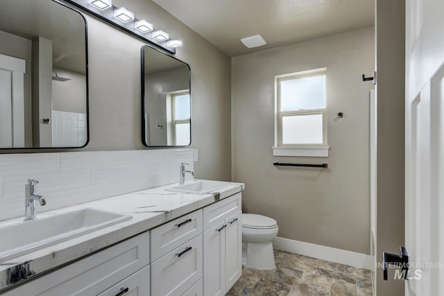 1113 W Blaine Ave, Nampa, ID 83651 - bathroom with a sink, baseboards, decorative backsplash, and toilet