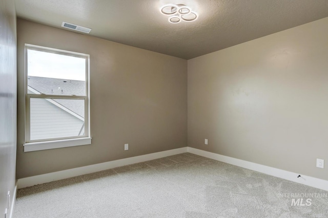 1113 W Blaine Ave, Nampa, ID 83651 - spare room with visible vents, baseboards, carpet floors, and a textured ceiling