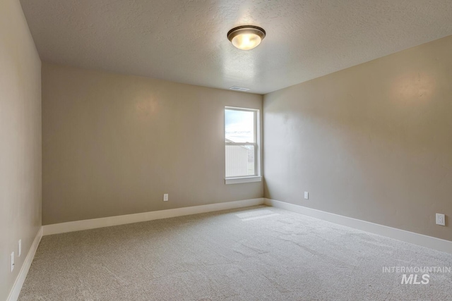1113 W Blaine Ave, Nampa, ID 83651 - unfurnished room with visible vents, baseboards, carpet, and a textured ceiling
