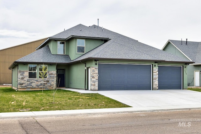 1113 W Blaine Ave, Nampa, ID 83651 - view of front of house with driveway, stone siding, a front lawn, a garage, and a shingled roof