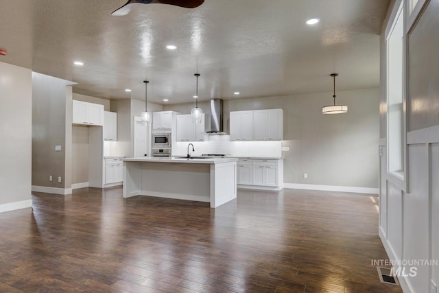 1113 W Blaine Ave, Nampa, ID 83651 - kitchen featuring baseboards, wall chimney exhaust hood, a sink, and ceiling fan