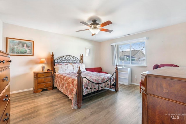 bedroom with ceiling fan and hardwood / wood-style flooring