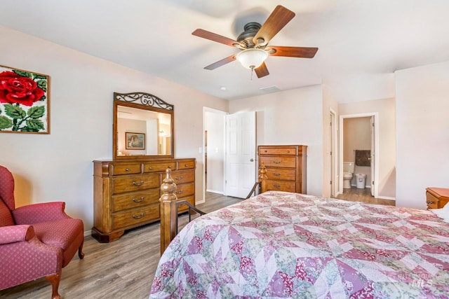 bedroom with hardwood / wood-style floors, ceiling fan, and connected bathroom