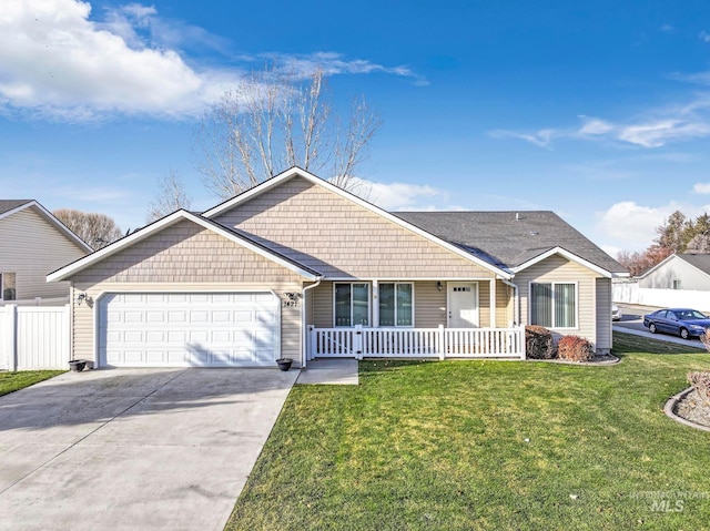 ranch-style house featuring a front yard, a porch, and a garage