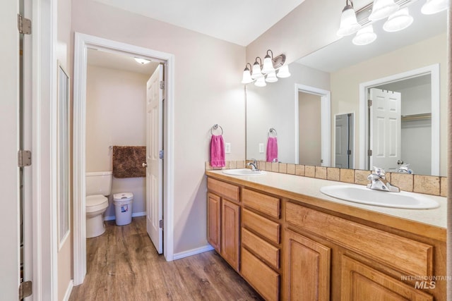 bathroom featuring hardwood / wood-style floors, vanity, and toilet