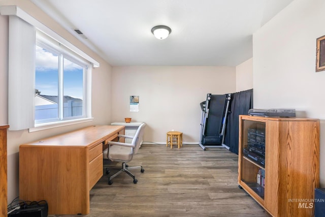 home office with dark wood-type flooring