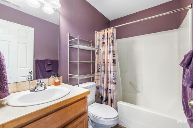 full bathroom with shower / bath combination with curtain, vanity, and toilet