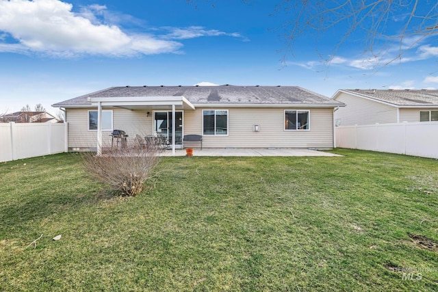 rear view of house featuring a patio area and a yard