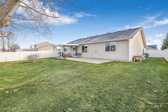 back of property with a patio and a lawn