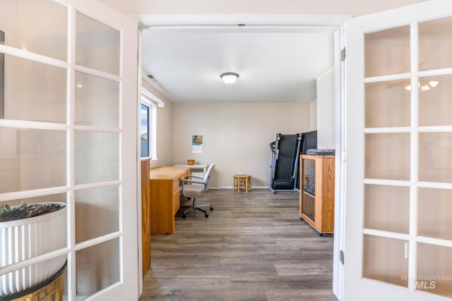 home office with dark hardwood / wood-style floors