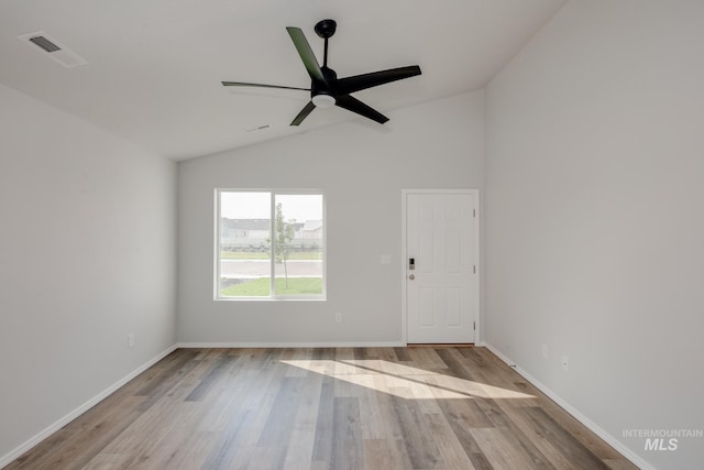 spare room with lofted ceiling, ceiling fan, and light hardwood / wood-style flooring