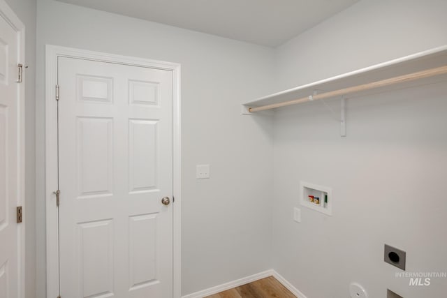 clothes washing area featuring washer hookup, hardwood / wood-style flooring, and hookup for an electric dryer