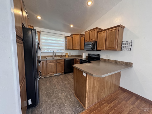 1173 Knoll Ridge Rd, Twin Falls, ID 83301 - kitchen with black appliances, a sink, a peninsula, vaulted ceiling, and brown cabinets