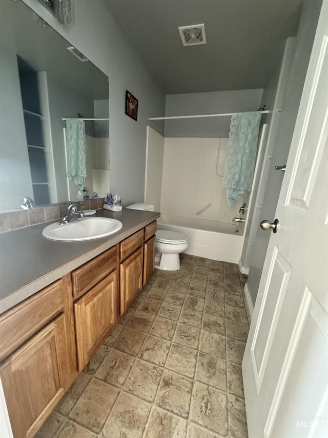 1173 Knoll Ridge Rd, Twin Falls, ID 83301 - bathroom featuring toilet, vanity, shower / tub combo, and stone tile floors