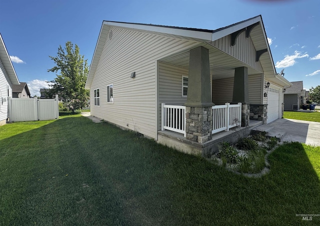 1173 Knoll Ridge Rd, Twin Falls, ID 83301 - view of home's exterior with covered porch, a garage, concrete driveway, and stone siding