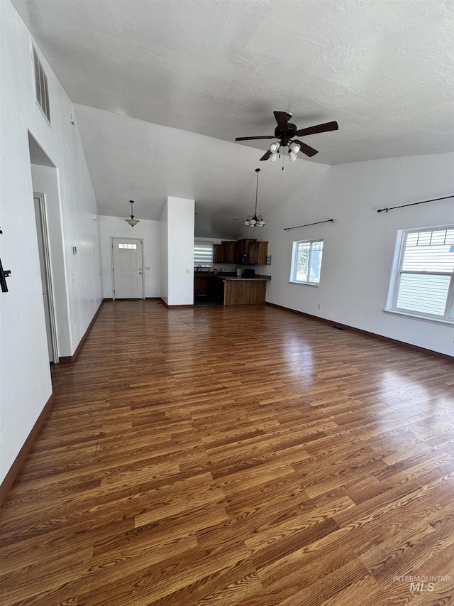1173 Knoll Ridge Rd, Twin Falls, ID 83301 - unfurnished living room with vaulted ceiling, a ceiling fan, dark wood-type flooring, and baseboards