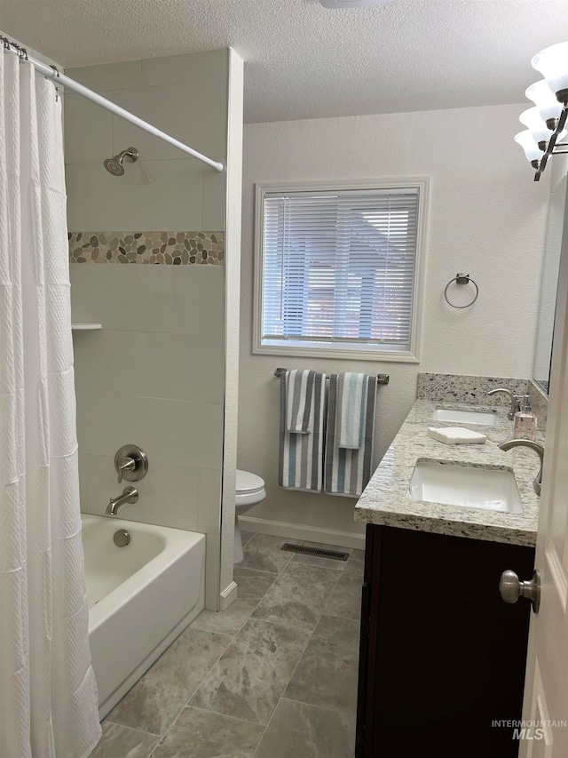 full bathroom featuring shower / bath combo, double sink vanity, a textured ceiling, tile flooring, and toilet