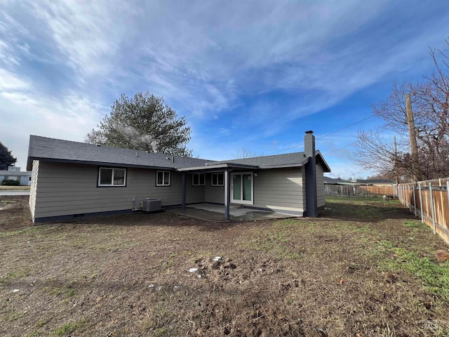 back of property with central AC unit and a patio area