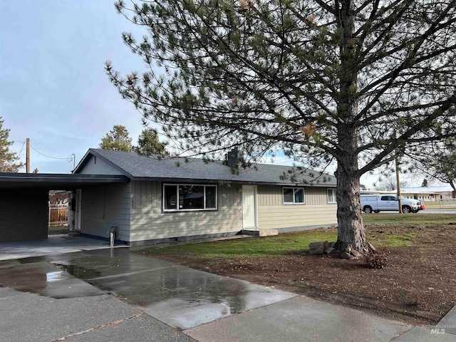 ranch-style home featuring a carport