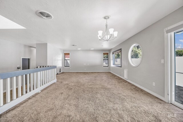 790 Academic Dr, Twin Falls, ID 83301 - living area with an inviting chandelier, baseboards, visible vents, and carpet floors