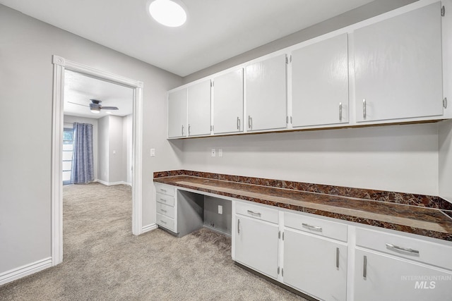 790 Academic Dr, Twin Falls, ID 83301 - interior space with white cabinetry, built in study area, dark countertops, and light carpet