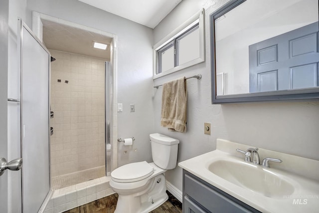 790 Academic Dr, Twin Falls, ID 83301 - bathroom featuring toilet, wood finished floors, baseboards, and a shower stall