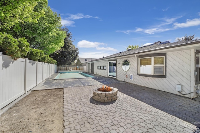790 Academic Dr, Twin Falls, ID 83301 - view of patio with an outdoor fire pit, a fenced backyard, and a fenced in pool