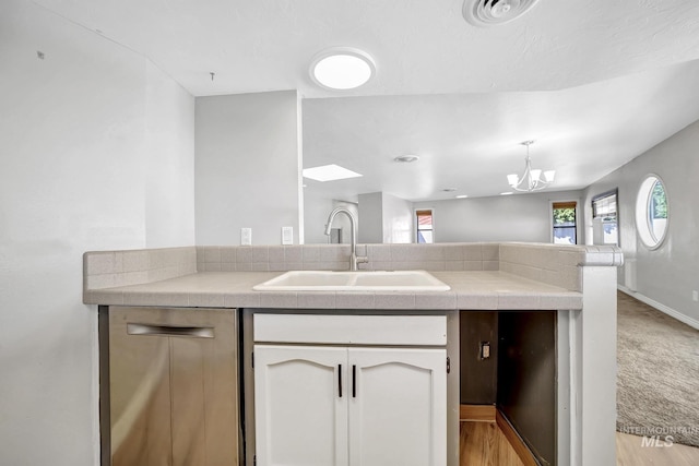 790 Academic Dr, Twin Falls, ID 83301 - kitchen featuring visible vents, a notable chandelier, a sink, tile counters, and white cabinetry
